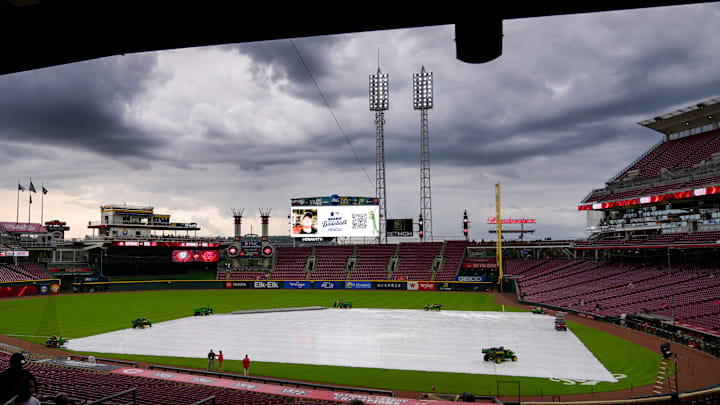 Fans make their ways into the stadium as a rain delay is announced before the first inning of the MLB National League game between the Cincinnati Reds and the Washington Nationals at Great American Ball Park in downtown Cincinnati on Friday, May 2, 2025.