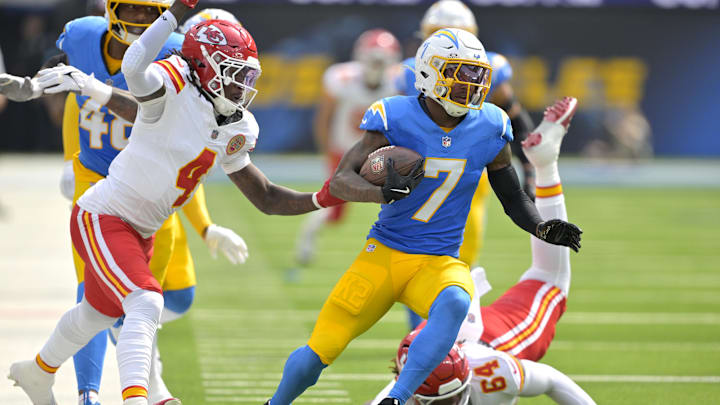Sep 29, 2024; Inglewood, California, USA;  Los Angeles Chargers cornerback Kristian Fulton (7) avoids a tackle by Kansas City Chiefs wide receiver Rashee Rice (4) and offensive tackle Wanya Morris (64) after an interception in the first half at SoFi Stadium.  