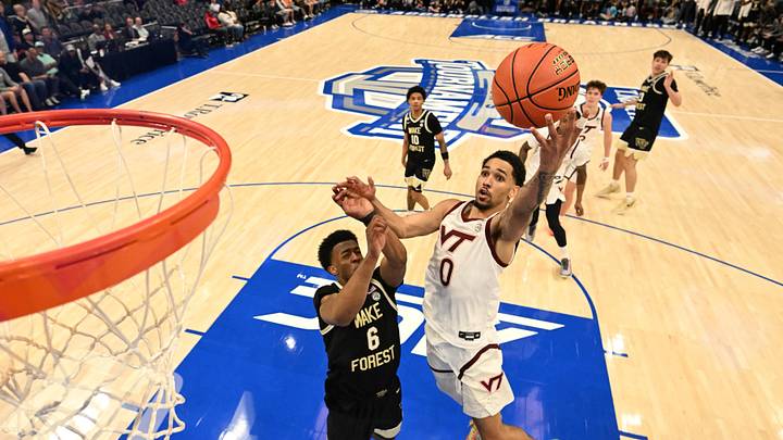 Mar 10, 2026; Charlotte, NC; Virginia Tech guard Jailen Bedford (0) shoots as Wake Forest guard Myles Colvin (6) defends.