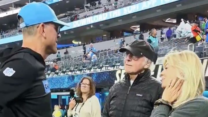 Los Angeles Chargers coach Jim Harbaugh meets with Larry David before a game at SoFi Stadium on December 19, 2024. 