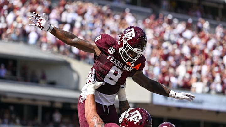 Oct 5, 2024; College Station, Texas, USA; Texas A&M Aggies running back Le'Veon Moss (8) celebrates with offensive lineman Chase Bisontis (71) after scoring a touchdown in the second quarter against the Missouri Tigers at Kyle Field. Mandatory Credit: Maria Lysaker-Imagn Images. 