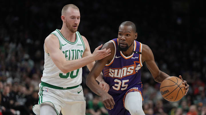 Mar 26, 2025; Phoenix, Arizona, USA; Phoenix Suns forward Kevin Durant (35) drives against Boston Celtics forward Sam Hauser (30) during the first half at Footprint Center. Mandatory Credit: Rick Scuteri-Imagn Images