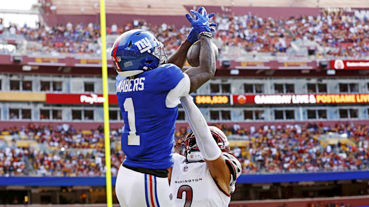 Sep 7, 2025; Landover, Maryland, USA; New York Giants wide receiver Malik Nabers (1) jumps up to make a catch during the fourth quarter against the Washington Commanders at Northwest Stadium. Mandatory Credit: Peter Casey-Imagn Images