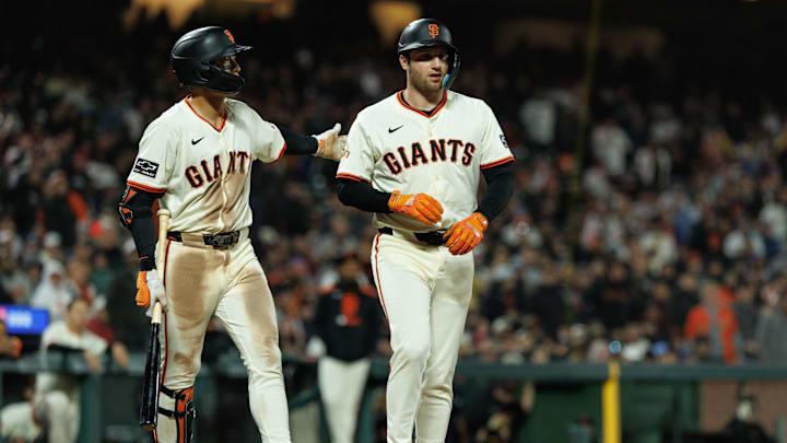 Jun 25, 2025; San Francisco, California, USA; San Francisco Giants first baseman Casey Schmitt (10) walks to first after getting hit by a pitch during the ninth inning against the Miami Marlins at Oracle Park. Mandatory Credit: Sergio Estrada-Imagn Images