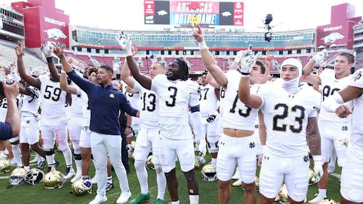 Sep 27, 2025; Fayetteville, Arkansas, USA; Notre Dame Fighting Irish head coach Marcus Freeman leads the team in celebration after the game against the Arkansas Razorbacks at Donald W. Reynolds Razorback Stadium. Notre Dame won 56-13. Mandatory Credit: Nelson Chenault-Imagn Images