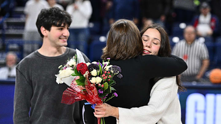 Feb 26, 2026; Spokane, Washington, USA; Gonzaga Bulldogs guard Vera Gunaydin (2) is hugged by head coach Lisa Fortier before a game against the Saint Mary's Gaels at McCarthey Athletic Center.