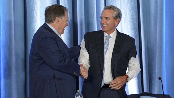 Dec 12, 2024; Chapel Hill, NC, USA; North Carolina Tar Heels new head coach Bill Belichick shares a moment with athletic director Bubba Cunningham at Loudermilk Center for Excellence. Mandatory Credit: Jim Dedmon-Imagn Images Dec 12, 2024; Chapel Hill, NC, USA; North Carolina Tar Heels new head coach Bill Belichick shares a moment with athletic director Bubba Cunningham at Loudermilk Center for Excellence. Mandatory Credit: Jim Dedmon-Imagn Images
