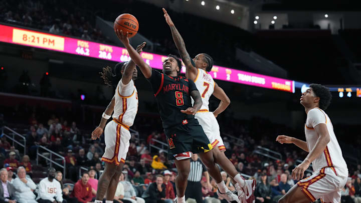 Jan 13, 2026; Los Angeles, California, USA; Maryland Terrapins guard David Coit (8) shoots the ball against Southern California Trojans guard Kam Woods (13) and guard Jordan Marsh (7) in the first half at Galen Center. Mandatory Credit: Kirby Lee-Imagn Images Jan 13, 2026; Los Angeles, California, USA; Maryland Terrapins guard David Coit (8) shoots the ball against Southern California Trojans guard Kam Woods (13) and guard Jordan Marsh (7) in the first half at Galen Center. Mandatory Credit: Kirby Lee-Imagn Images