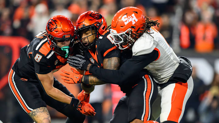 Nov 8, 2025; Corvallis, Oregon, USA; Sam Houston Bearkats defensive back Cecil Powell (2) stops Oregon State Beavers running back Anthony Hankerson (0) in the backfield for a loss during the second quarter at Reser Stadium. Mandatory Credit: Craig Strobeck-Imagn Images