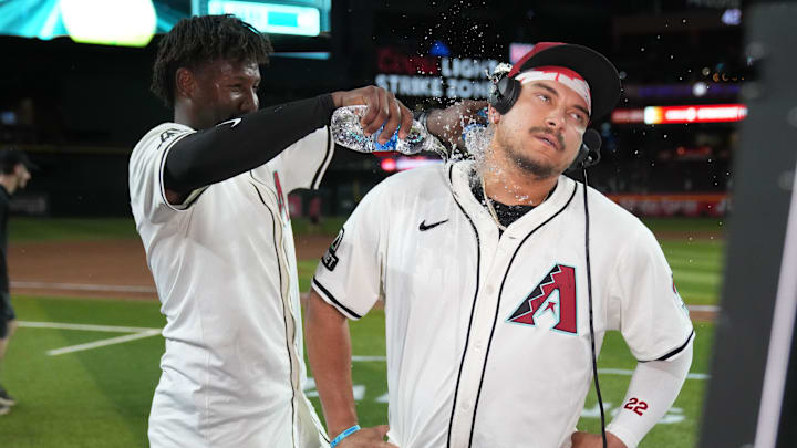 Arizona Diamondbacks first base Josh Naylor (22) celebrates with shortstop Geraldo Perdomo (2) after hitting a walk off grand slam home run against the Seattle Mariners in the eleventh inning at Chase Field on June 9. 