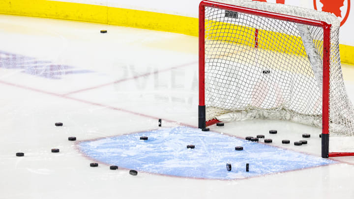 Nov 3, 2024; Calgary, Alberta, CAN; General view of the net with pucks during the warmup period between the Calgary Flames and the Edmonton Oilers at Scotiabank Saddledome. Mandatory Credit: Sergei Belski-Imagn Images