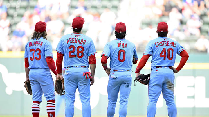 May 31, 2025; Arlington, Texas, USA; St. Louis Cardinals second baseman Brendan Donovan (33) and third baseman Nolan Arenado (28) and shortstop Masyn Winn (0) and first baseman Willson Contreras (40) check the replay of Texas Rangers center fielder Wyatt Langford (not pictured) being called out at first base during the ninth inning at Globe Life Field. Mandatory Credit: Jerome Miron-Imagn Images