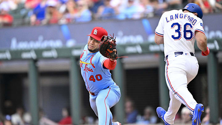 May 31, 2025; Arlington, Texas, USA; St. Louis Cardinals first baseman Willson Contreras (40) catches a throw to first base and puts out Texas Rangers center fielder Wyatt Langford (36) during the ninth inning at Globe Life Field. Mandatory Credit: Jerome Miron-Imagn Images