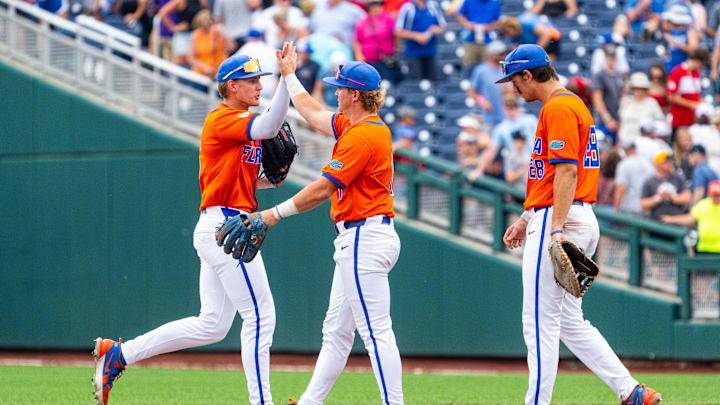 Jun 17, 2024; Omaha, NE, USA; Florida Gators third baseman Dale Thomas (1) and left fielder Tyler Shelnut (6) celebrate after defeating the NC State Wolfpack at Charles Schwab Field Omaha. Mandatory Credit: Dylan Widger-USA TODAY Sports