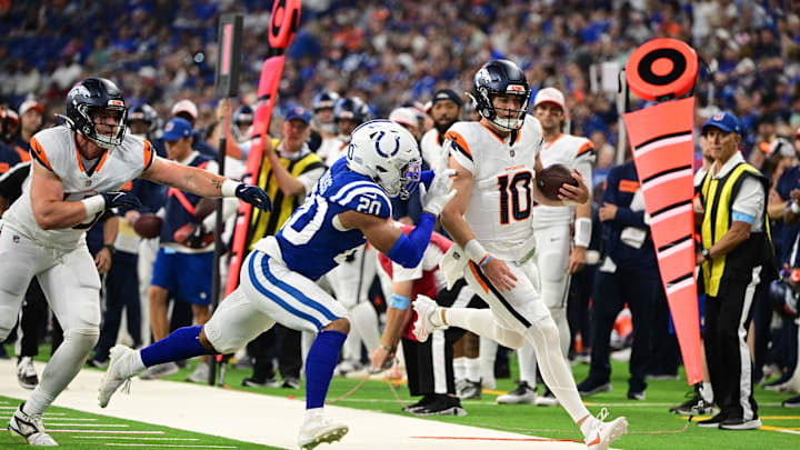 Aug 11, 2024; Indianapolis, Indiana, USA;  Denver Broncos quarterback Bo Nix (10) is pushed out of bounds by Indianapolis Colts safety Nick Cross (20) during the second quarter at Lucas Oil Stadium. Mandatory Credit: Marc Lebryk-USA TODAY Sports