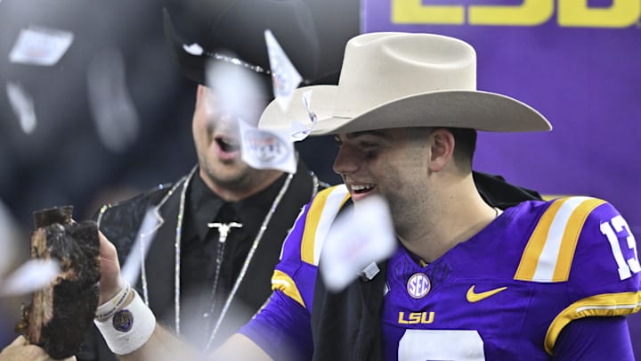 Dec 31, 2024; Houston, TX, USA; LSU Tigers quarterback Garrett Nussmeier (13) receives a Kinder BBQ rib during the post game celebration at NRG Stadium. The Tigers defeat the Bears 44-31. Mandatory Credit: Maria Lysaker-Imagn Images 