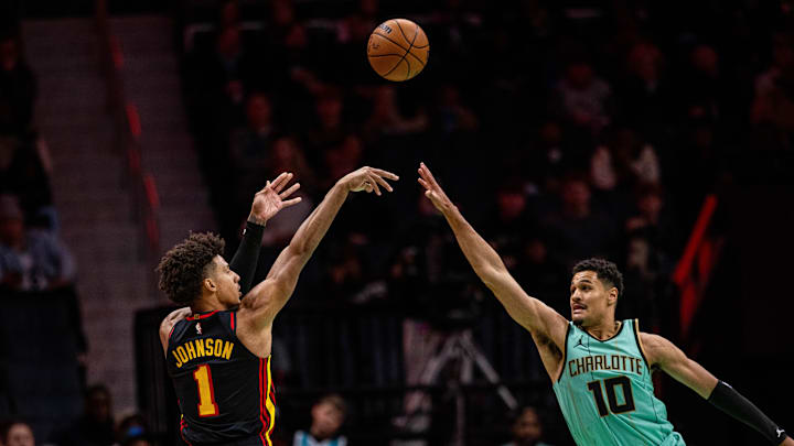 Nov 30, 2024; Charlotte, North Carolina, USA; Atlanta Hawks forward Jalen Johnson (1) shoots the ball against Charlotte Hornets guard Josh Green (10) during the fourth quarter at Spectrum Center. Mandatory Credit: Scott Kinser-Imagn Images