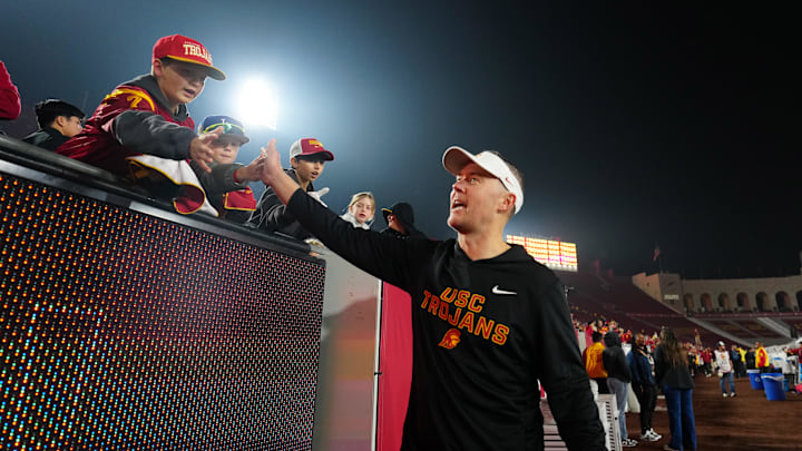 Nov 29, 2025; Los Angeles, California, USA; Southern California Trojans head coach Lincoln Riley celebrates with fans after the game against the UCLA Bruins at United Airlines Field at Los Angeles Memorial Coliseum. Mandatory Credit: Kirby Lee-Imagn Images Nov 29, 2025; Los Angeles, California, USA; Southern California Trojans head coach Lincoln Riley celebrates with fans after the game against the UCLA Bruins at United Airlines Field at Los Angeles Memorial Coliseum. Mandatory Credit: Kirby Lee-Imagn Images