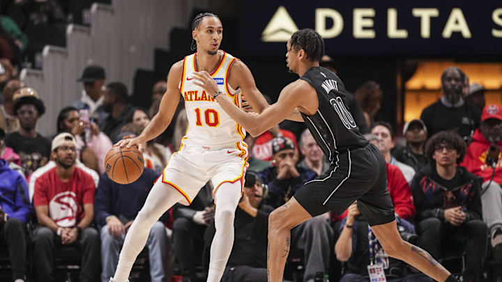 Mar 12, 2026; Atlanta, Georgia, USA; Atlanta Hawks forward Zaccharie Risacher (10) dribbles against Brooklyn Nets forward Josh Minott (00) during the first half at State Farm Arena. Mandatory Credit: Dale Zanine-Imagn Images