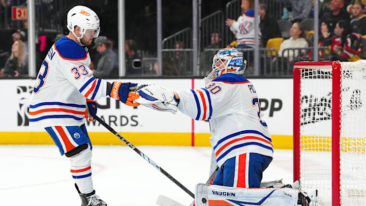 Apr 1, 2025; Las Vegas, Nevada, USA; Edmonton Oilers left wing Viktor Arvidsson (33) celebrates with Edmonton Oilers goaltender Calvin Pickard (30) after scoring a goal against the Vegas Golden Knights during the second period at T-Mobile Arena. Mandatory Credit: Stephen R. Sylvanie-Imagn Images