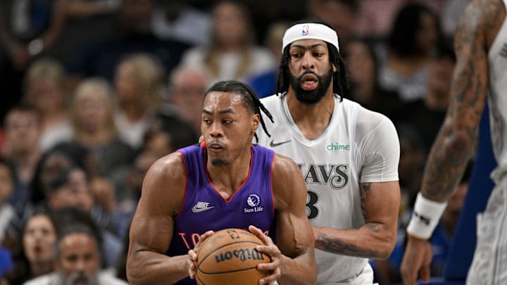 Apr 11, 2025; Dallas, Texas, USA; Toronto Raptors guard Ochai Agbaji (30) looks to move the ball past Dallas Mavericks forward Anthony Davis (3) during the second half at the American Airlines Center. Mandatory Credit: Jerome Miron-Imagn Images