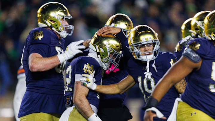Notre Dame running back Aneyas Williams, second from left, celebrates with teammates after scoring a touchdown in the second half of a NCAA football game against Syracuse at Notre Dame Stadium on Saturday, Nov. 22, 2025, in South Bend.
