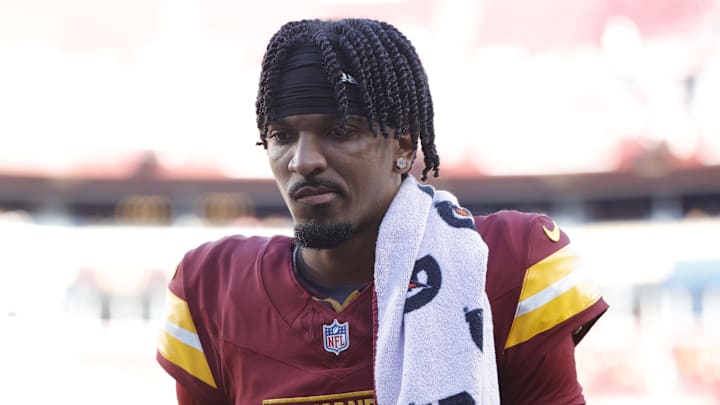 Oct 20, 2024; Landover, Maryland, USA; Washington Commanders quarterback Jayden Daniels (5) walks off the field during the first quarter after an injury against the Carolina Panthers at Northwest Stadium. Mandatory Credit: Amber Searls-Imagn Images