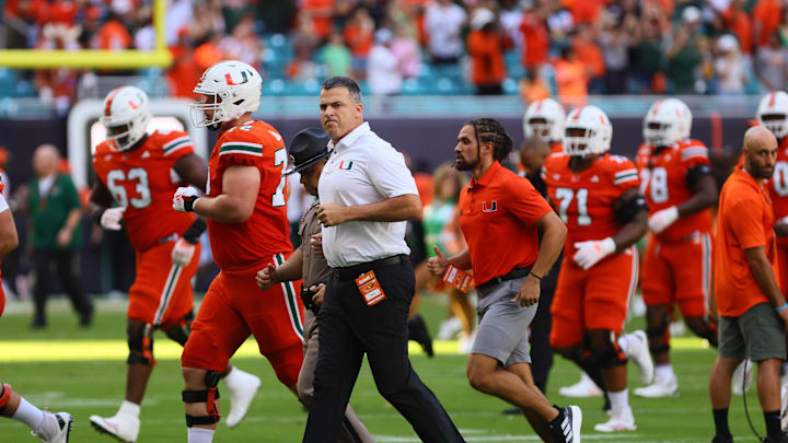 Sep 7, 2024; Miami Gardens, Florida, USA; Miami Hurricanes head coach Mario Cristobal runs on the field before the game against the Florida A&M Rattlers at Hard Rock Stadium. Mandatory Credit: Sam Navarro-Imagn Images