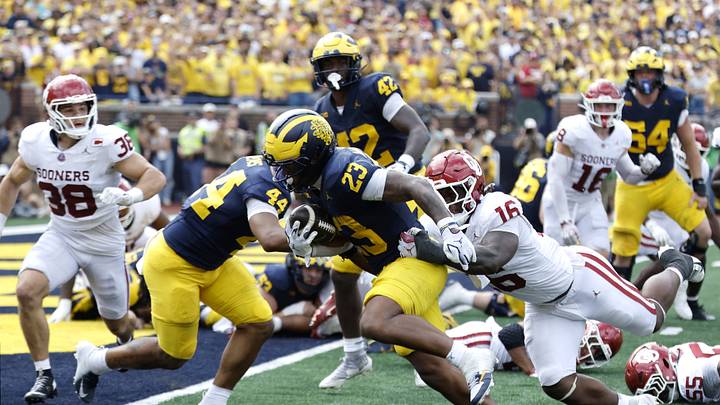 Sep 12, 2026; Ann Arbor, Michigan, USA; Michigan Wolverines running back Jordan Marshall (23) carries the ball for a touchdown defended by Oklahoma Sooners defensive line Danny Okoye (16) during the fourth quarter at Michigan Stadium. Mandatory Credit: Rick Osentoski-Imagn Images Sep 12, 2026; Ann Arbor, Michigan, USA; Michigan Wolverines running back Jordan Marshall (23) carries the ball for a touchdown defended by Oklahoma Sooners defensive line Danny Okoye (16) during the fourth quarter at Michigan Stadium. Mandatory Credit: Rick Osentoski-Imagn Images