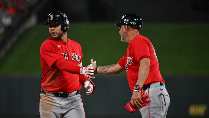 Apr 11, 2026; St. Louis, Missouri, USA; Boston Red Sox first baseman Willson Contreras (40) celebrates with first base coach José David Flores (58) after hitting a one run single against the St. Louis Cardinals during the ninth inning at Busch Stadium. Mandatory Credit: Jeff Curry-Imagn Images
