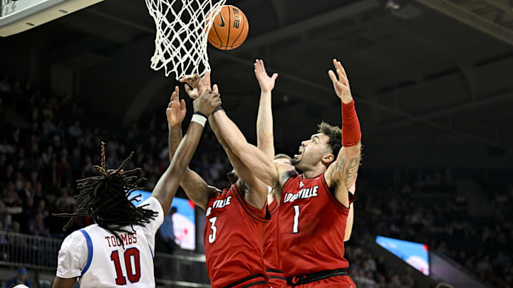 Feb 17, 2026; Dallas, Texas, USA; SMU Mustangs center Jaden Toombs (10) and Louisville Cardinals guard Ryan Conwell (3) and guard J'vonne Hadley (1) battle for the rebound during the second half at Moody Coliseum. Mandatory Credit: Jerome Miron-Imagn Images