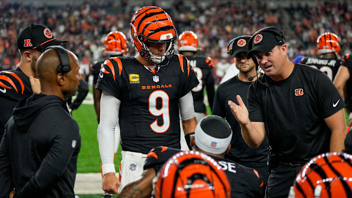 Cincinnati Bengals quarterback Joe Burrow (9) and head coach Zac Taylor talk with wide receiver Ja'Marr Chase (1) on the bench after a drive in the fourth quarter of the NFL Week 3 game between the Cincinnati Bengals and the Washington Commanders at Paycor Stadium in downtown Cincinnati on Monday, Sept. 23, 2024. The Bengals remain winless after a 38-33 loss to Washington.