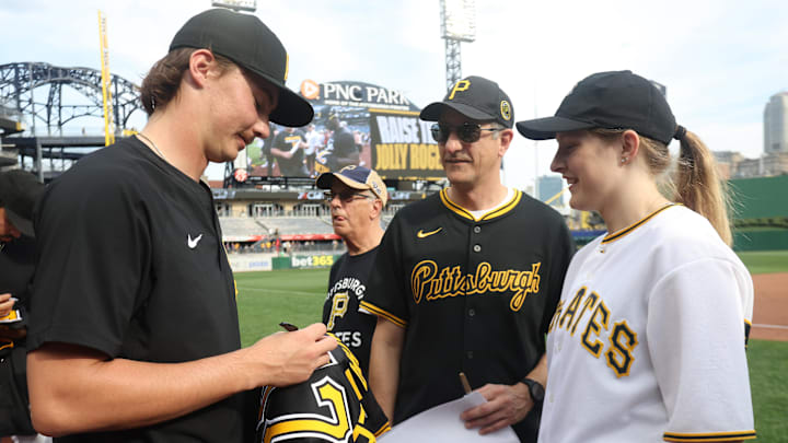 Sep 21, 2025; Pittsburgh, Pennsylvania, USA; Pittsburgh Pirates pitcher Bubba Chandler (57) signs his game jersey as part of a fan appreciation promotion following the game against the Athletics at PNC Park. Mandatory Credit: Charles LeClaire-Imagn Images Sep 21, 2025; Pittsburgh, Pennsylvania, USA; Pittsburgh Pirates pitcher Bubba Chandler (57) signs his game jersey as part of a fan appreciation promotion following the game against the Athletics at PNC Park. Mandatory Credit: Charles LeClaire-Imagn Images