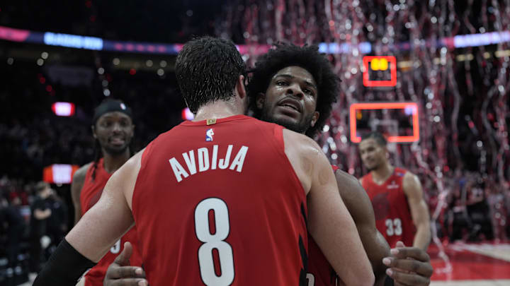 Dec 26, 2024; Portland, Oregon, USA; Portland Trail Blazers guard Scoot Henderson (00) celebrates with small forward Deni Avdija (8) after making the game-winning basket against the Utah Jazz at Moda Center. Mandatory Credit: Soobum Im-Imagn Images