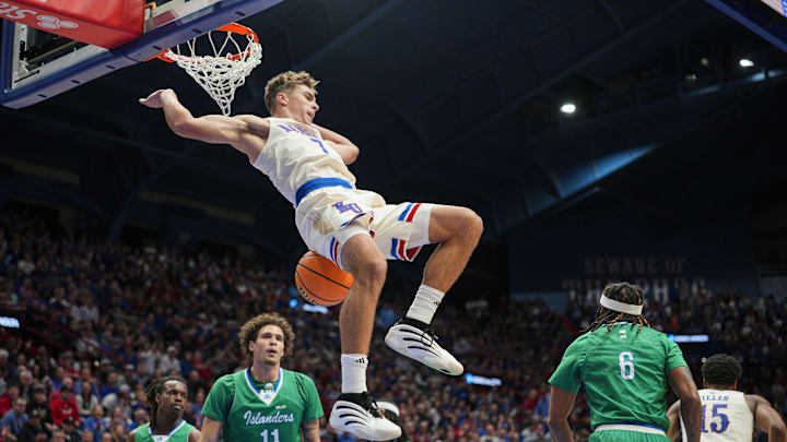 Nov 11, 2025; Lawrence, Kansas, USA; Kansas Jayhawks guard Kohl Rosario (7) dunks the ball during the first half against the Texas A&M-Corpus Christi Islanders at Allen Fieldhouse. Mandatory Credit: Jay Biggerstaff-Imagn Images