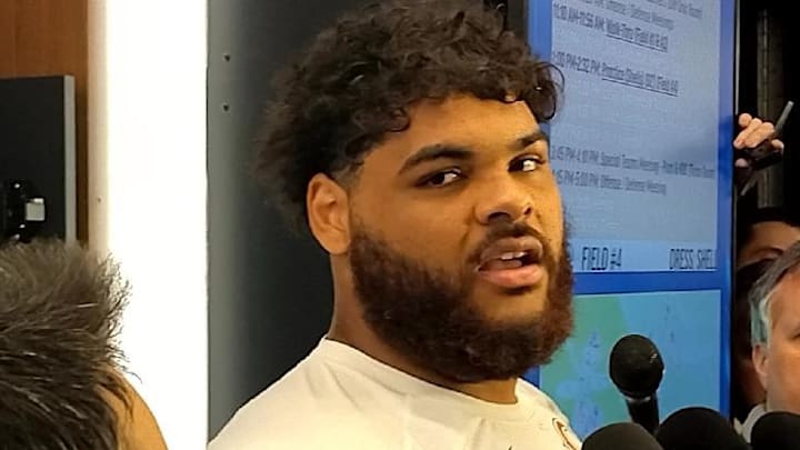 Darnell Wright discusses his play and cartwheel with reporters Wednesday at Halas Hall.