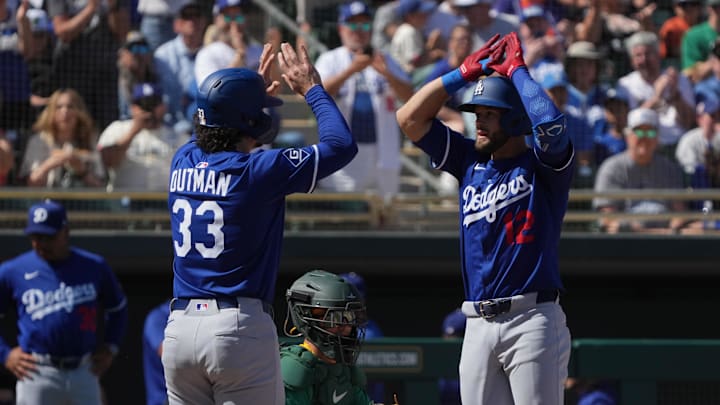 Mar 2, 2025; Mesa, Arizona, USA; Los Angeles Dodgers David Bote celebrates with outfielder James Outman (33) after hitting a two run home run in the second inning at Hohokam Stadium. Mandatory Credit: Rick Scuteri-Imagn Images