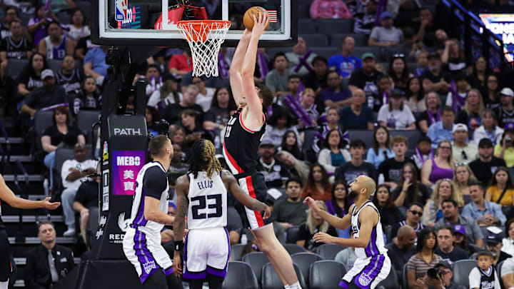 Oct 13, 2024; Sacramento, California, USA; Portland Trail Blazers center Donovan Clingan (23) dunks the ball over Sacramento Kings center Alex Len (25) during the fourth quarter at Golden 1 Center. Mandatory Credit: Sergio Estrada-Imagn Images