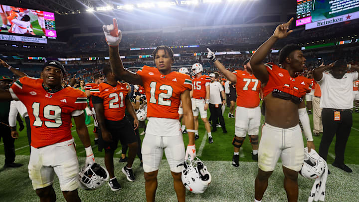 Sep 27, 2024; Miami Gardens, Florida, USA; Miami Hurricanes wide receiver Robby Washington (12) celebrates with teammates after the game against the Virginia Tech Hokies at Hard Rock Stadium. Mandatory Credit: Sam Navarro-Imagn Images
