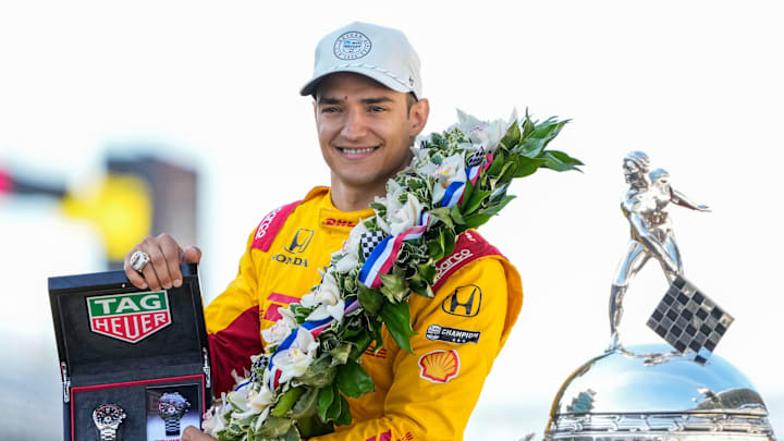 Alex Palou poses for photos after his Indy 500 victory.