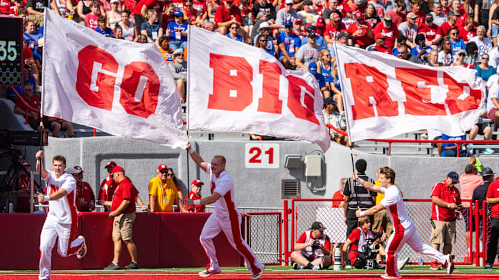 Sep 13, 2025; Lincoln, Nebraska, USA; Nebraska Cornhuskers cheerleaders run with flags after a score against the Houston Christian Huskies during the first quarter at Memorial Stadium. Sep 13, 2025; Lincoln, Nebraska, USA; Nebraska Cornhuskers cheerleaders run with flags after a score against the Houston Christian Huskies during the first quarter at Memorial Stadium.