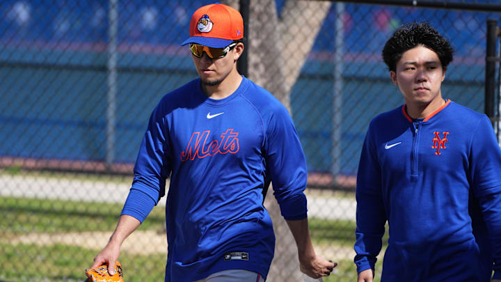 Feb 16, 2025; Port St. Lucie, FL, USA; New York Mets pitcher Kodai Senga, left, walks back to the clubhouse during spring training. Mandatory Credit: Jim Rassol-Imagn Images