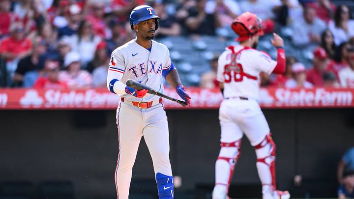 Texas Rangers left fielder Andrew McCutchen looks on after striking out.