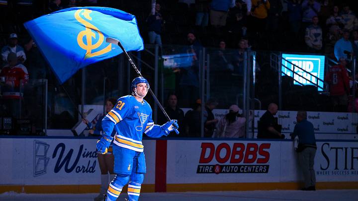 Mar 24, 2026; St. Louis, Missouri, USA; St. Louis Blues right wing Jimmy Snuggerud (21) salutes the fans after he was named second star of the game after a victory over the Washington Capitals at Enterprise Center. Mandatory Credit: Jeff Curry-Imagn Images