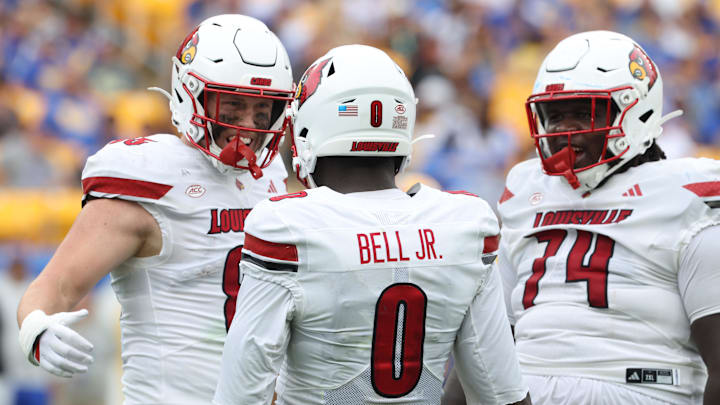 Sep 27, 2025; Pittsburgh, Pennsylvania, USA;  Louisville Cardinals wide receiver Chris Bell (0) celebrates his touchdown with tight end Nate Kurisky (85) and offensive lineman Jordan Church (74) against the Pittsburgh Panthers during the second quarter at Acrisure Stadium. Mandatory Credit: Charles LeClaire-Imagn Images