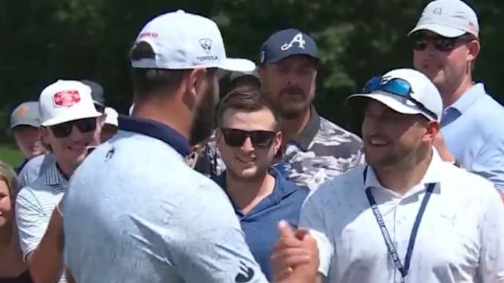 Rahm shaking hands with a fan he had accidentally hit with a shot moments before.