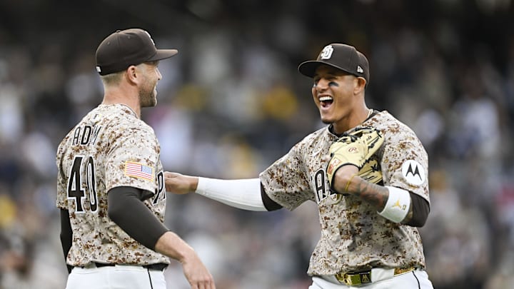 Mar 30, 2025; San Diego, California, USA; San Diego Padres third baseman Manny Machado (13), right, celebrates with Jason Adam (40) after turning a double play during the eighth inning against the Atlanta Braves at Petco Park. Mandatory Credit: Denis Poroy-Imagn Images Mar 30, 2025; San Diego, California, USA; San Diego Padres third baseman Manny Machado (13), right, celebrates with Jason Adam (40) after turning a double play during the eighth inning against the Atlanta Braves at Petco Park. Mandatory Credit: Denis Poroy-Imagn Images