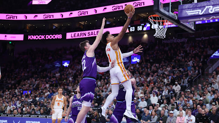 Nov 13, 2025; Salt Lake City, Utah, USA; Atlanta Hawks forward Jalen Johnson (1) lays the ball up against Utah Jazz forward Kyle Filipowski (22) during the first half at Delta Center. Mandatory Credit: Rob Gray-Imagn Images