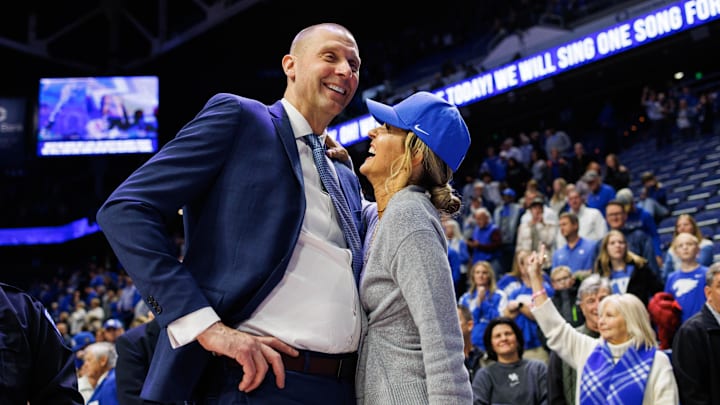 Nov 29, 2024; Lexington, Kentucky, USA; Kentucky Wildcats head coach Mark Pope talks with his wife Lee Anne after the game against the Georgia State Panthers at Rupp Arena at Central Bank Center. Mandatory Credit: Jordan Prather-Imagn Images