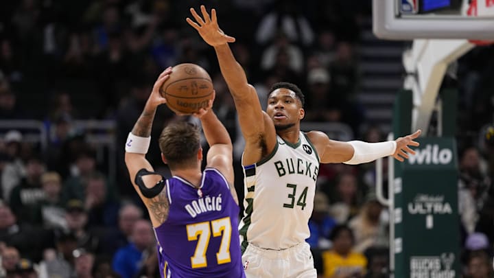 Nov 15, 2025; Milwaukee, Wisconsin, USA;  Milwaukee Bucks forward Giannis Antetokounmpo (34) defends Los Angeles Lakers guard Luka Doncic (77) during the first quarter at Fiserv Forum. Mandatory Credit: Jeff Hanisch-Imagn Images